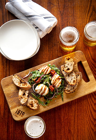 various food items displayed on a wooden cutting board