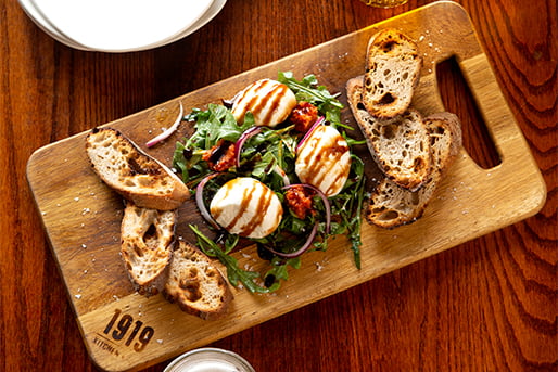 various food items displayed on a wooden cutting board